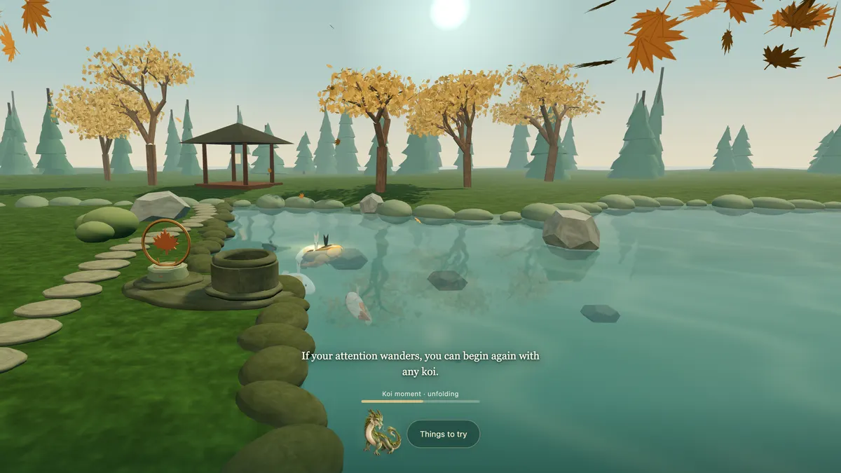 White, orange and gold koi gliding beneath the pond surface between dark stones